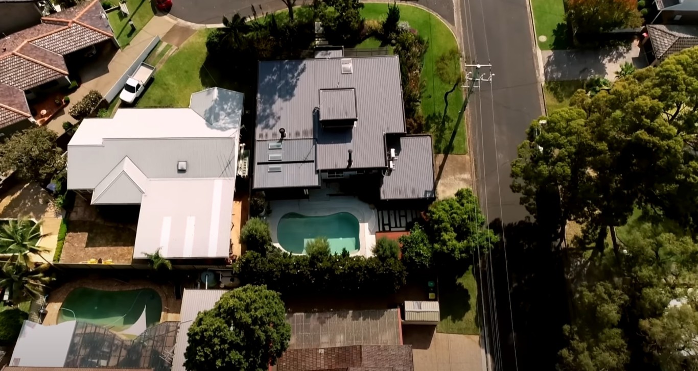 Aerial view of well-maintained residential property with pool and landscaping in Lynwood, CA