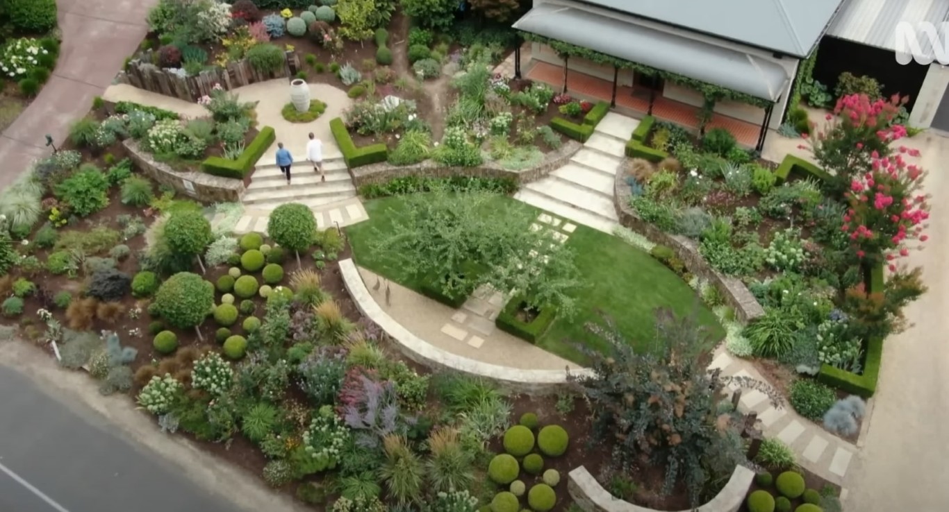 Beautiful terraced garden design with curved pathways and diverse plantings in Lynwood, CA